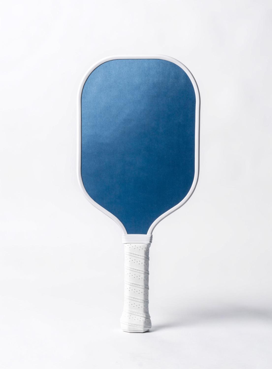 Representative photo of a pair of beginner fiberglass paddles and balls in a starter set; stands in for the JOOLA Essentials set.